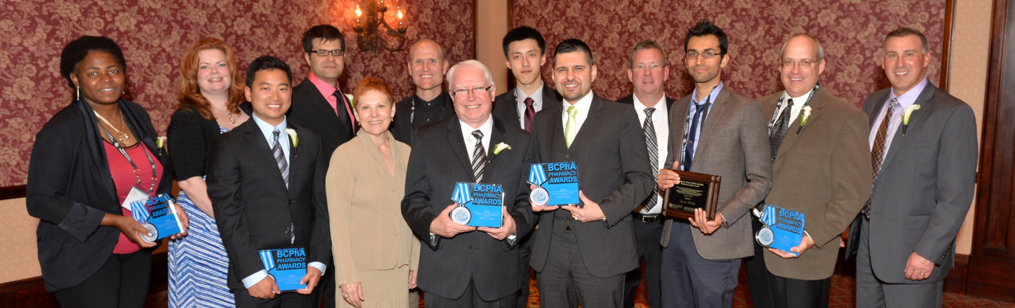 Celebrating the 2014 BCPhA Pharmacy Award recipients: (from left to right) Joelle Mbamy, Stephanie Hahn (accepting on behalf of Adeline Tan), Jason Min, Chris Cameron, BCPhA CEO Geraldine Vance, Mike Dilfer, Ken Foreman, Dawei Ji, Omar Alasaly, Don Fraser, Aaron Sihota, Cam Bonell and BCPhA president Don Cocar.