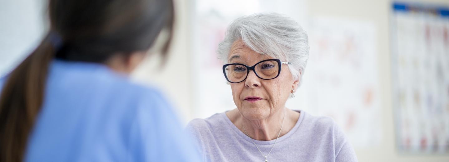 A senior talking to a healthcare professional