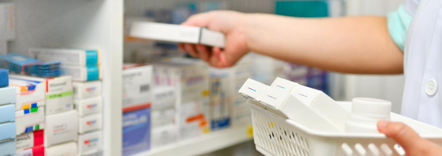 Pharmacist grabbing medication